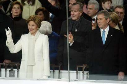 Mr. and Mrs. Bush flash the Horns